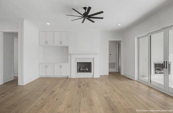 Bright living room with finished wood-look flooring by AVS Flooring